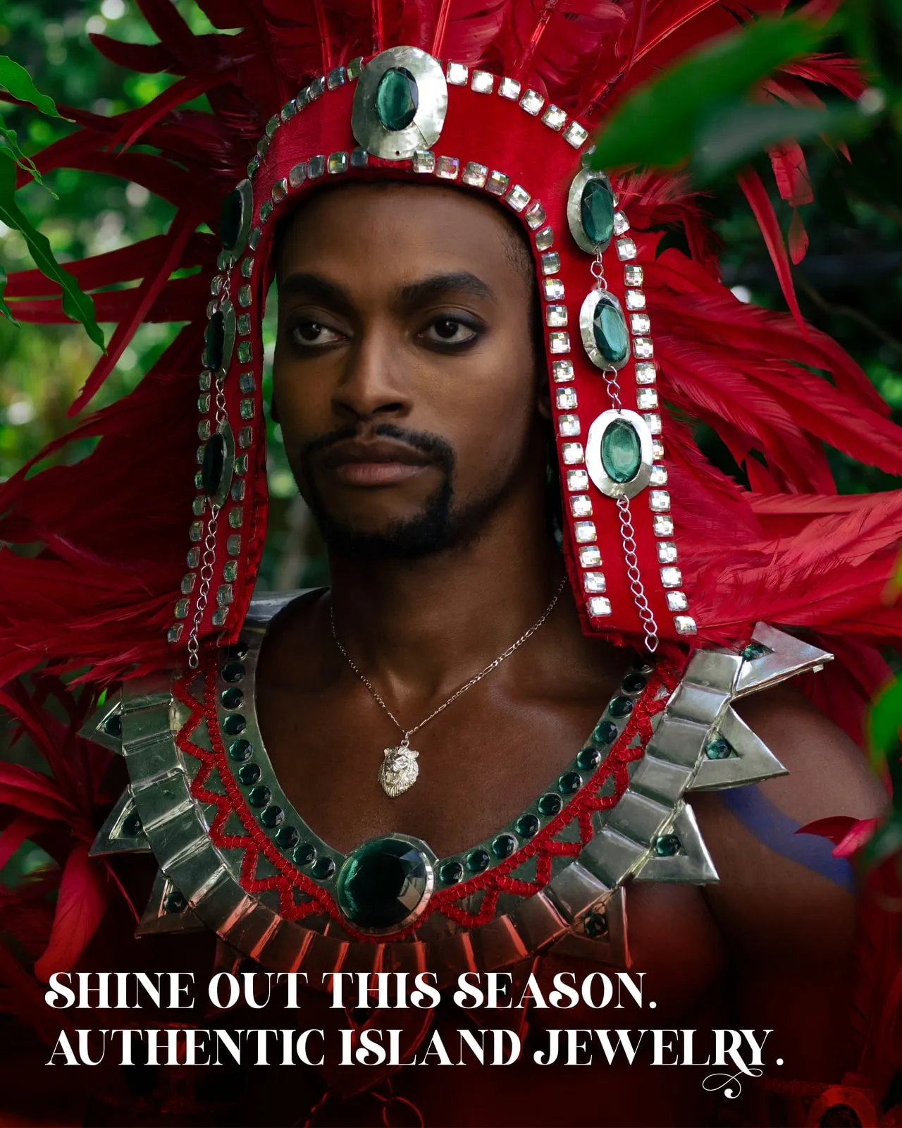 Caribbijou Carnival campaign: a masquerader in a red-feathered headdress and jewelled collar wearing a silver pendant, captioned "Shine out this season. Authentic island jewelry."